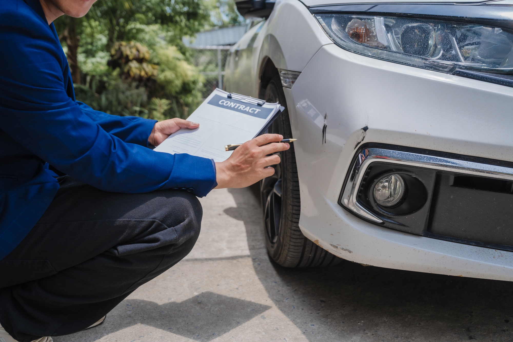 businessman in suit and car auto insurance agent assess car damage, discussing deductible, claims